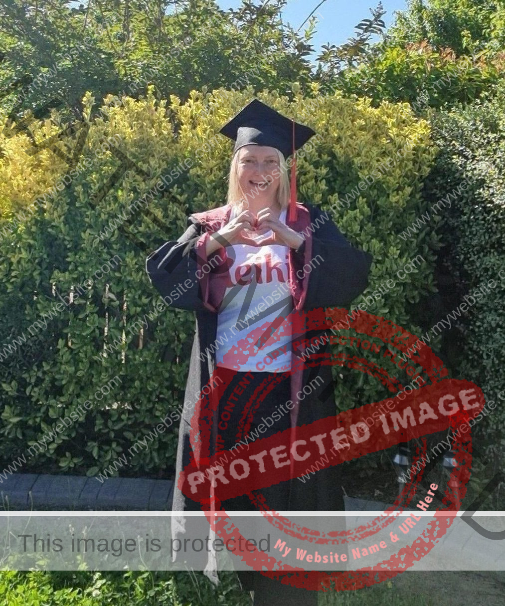 Diana Fels Reiki courses training, Reiki teacher with reiki shirt cap and gown, reiki love heart hands